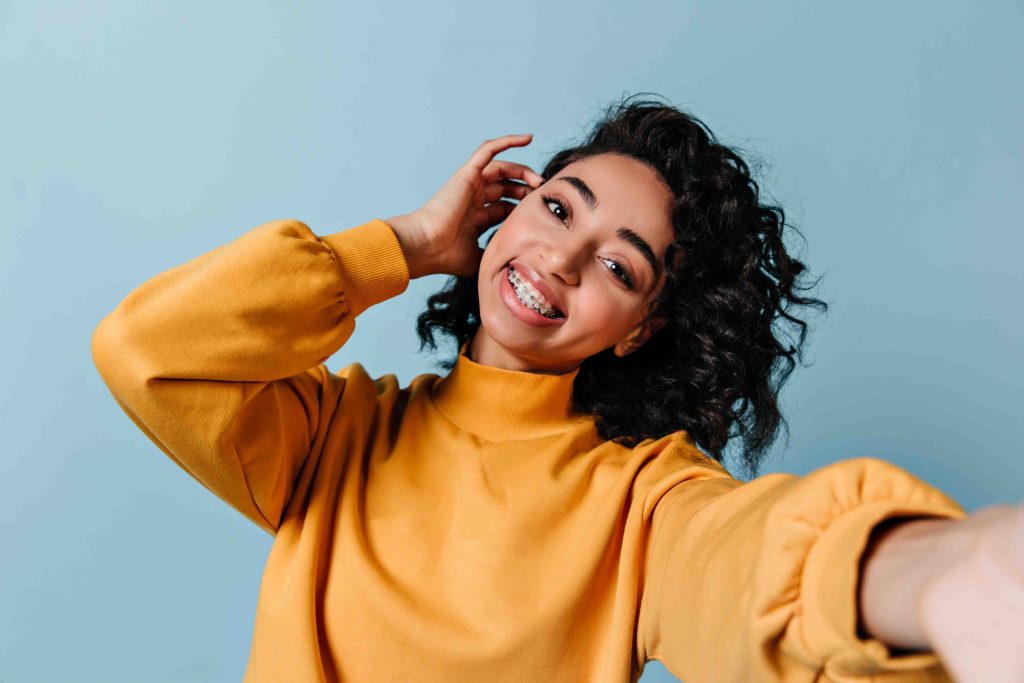 Smiling woman in a yellow sweater